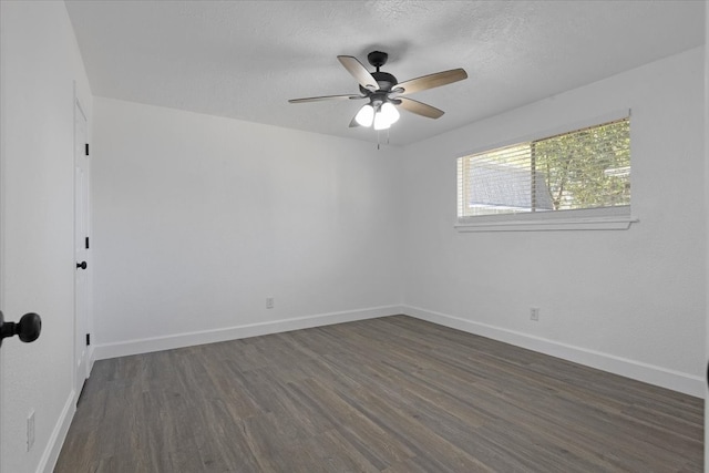 spare room with ceiling fan and dark wood-type flooring