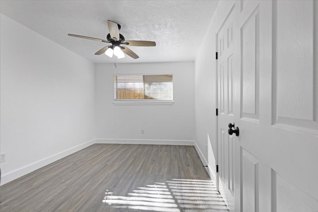 unfurnished room with a textured ceiling, light hardwood / wood-style floors, and ceiling fan