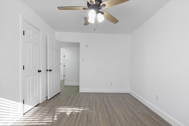 empty room with hardwood / wood-style flooring and ceiling fan