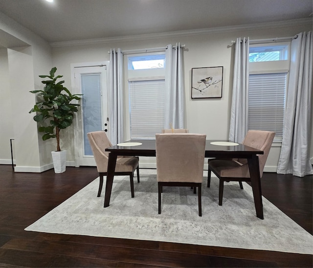 dining room featuring hardwood / wood-style floors, plenty of natural light, and ornamental molding