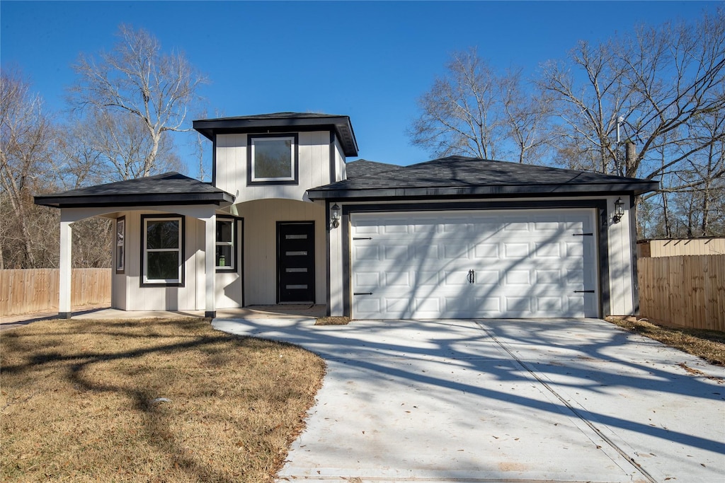 prairie-style home with a garage and a front yard