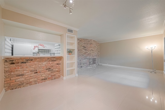 unfurnished living room with tile patterned floors, crown molding, built in features, and a textured ceiling