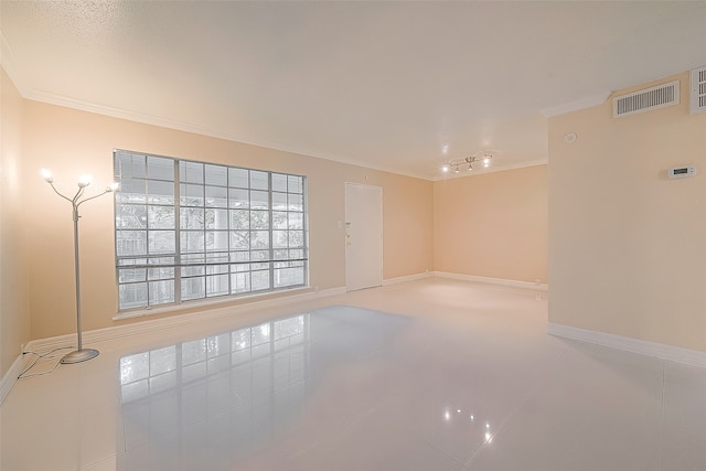 tiled empty room with crown molding