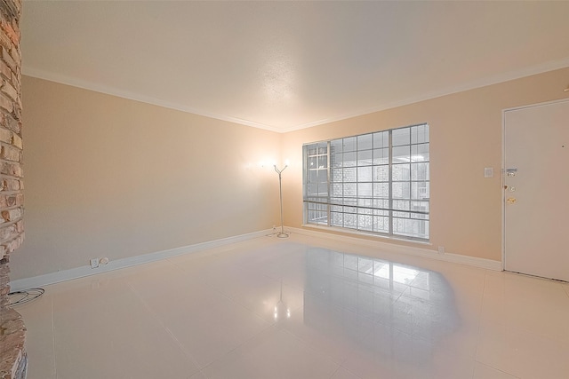 2121 Fountain View Dr Unit 22, Houston, TX 77057 - spare room featuring ornamental molding, baseboards, and tile patterned floors