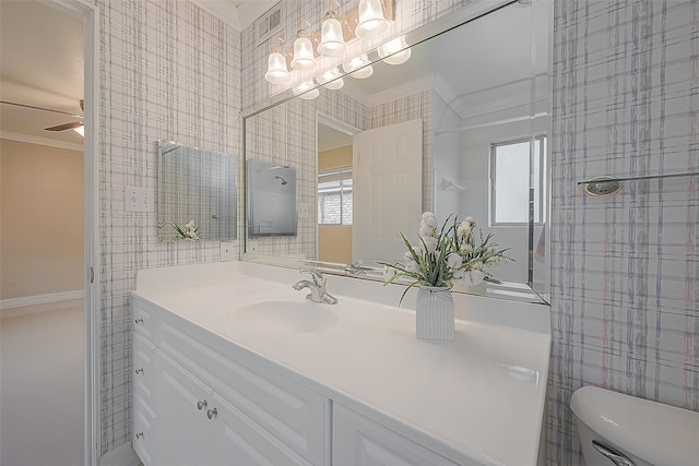 bathroom featuring vanity, ceiling fan, toilet, and crown molding