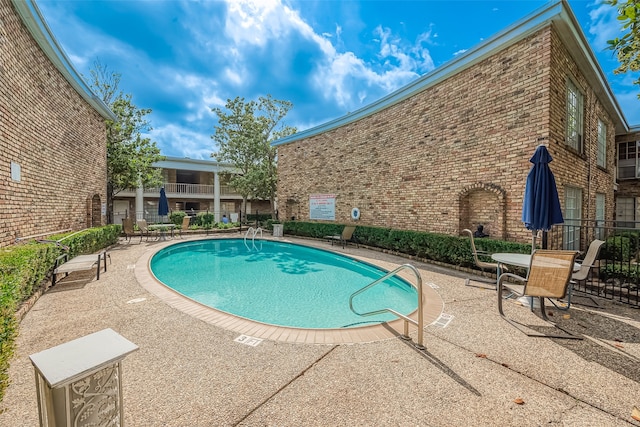 view of swimming pool featuring a patio area