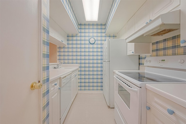 2121 Fountain View Dr Unit 22, Houston, TX 77057 - kitchen featuring white appliances, washing machine and clothes dryer, light countertops, and a sink
