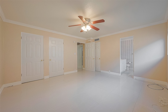 unfurnished bedroom featuring ceiling fan, light tile patterned flooring, ensuite bathroom, and ornamental molding