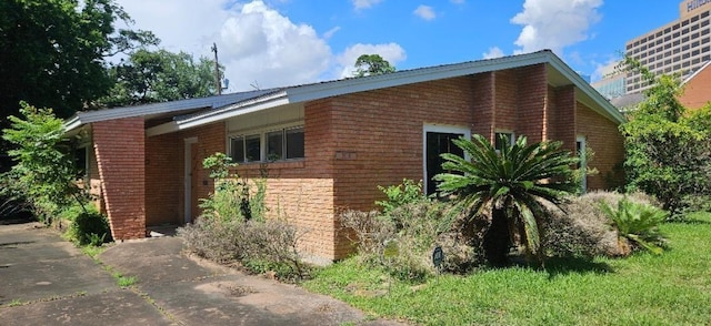 view of side of property with a lawn