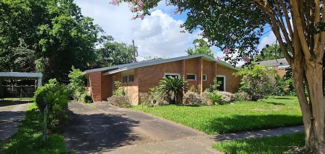 view of side of home featuring a yard