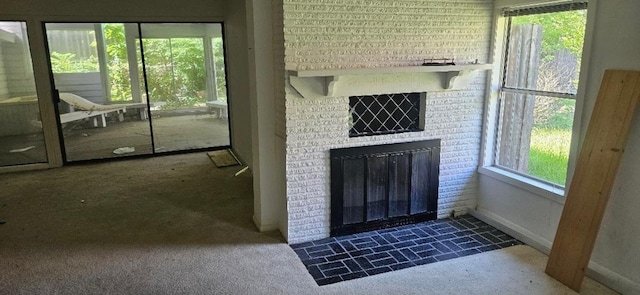 doorway featuring carpet flooring, a wealth of natural light, and a fireplace