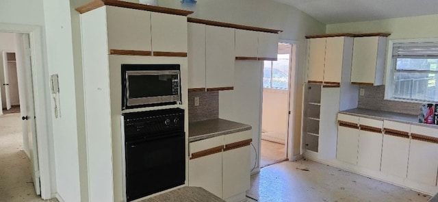 kitchen with backsplash, black oven, and white cabinetry