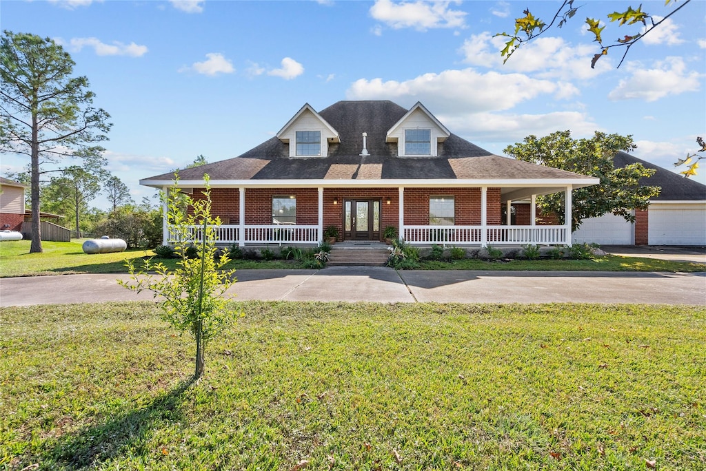5404 Autumn Ln, Dickinson, TX 77539 - view of front of property featuring a porch, brick siding, and a front lawn