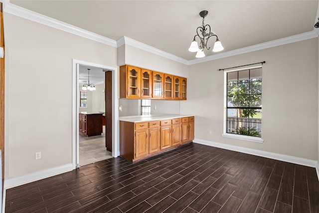 kitchen with ornamental molding, an inviting chandelier, and dark wood-type flooring