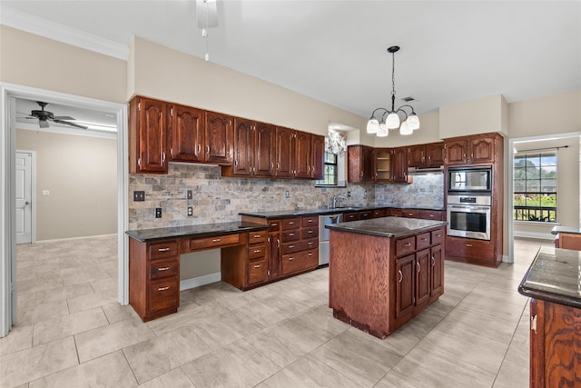 kitchen with sink, appliances with stainless steel finishes, a center island, and backsplash