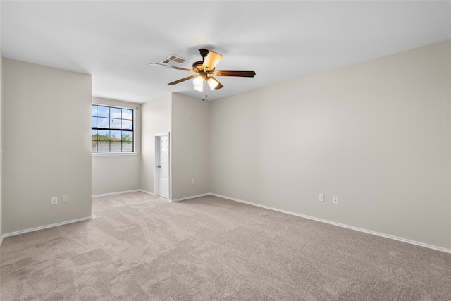 spare room with light carpet and ceiling fan