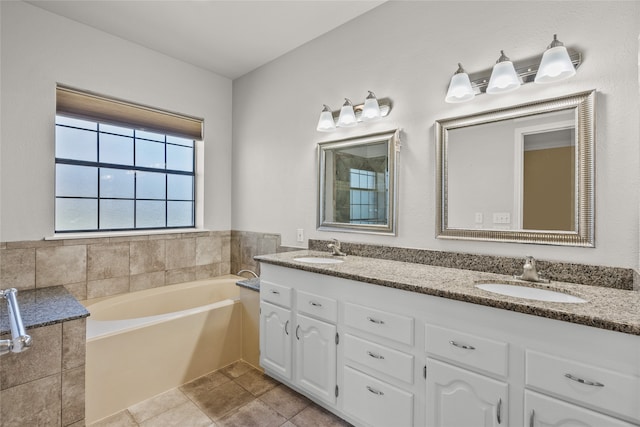 bathroom featuring tile patterned floors, vanity, and a bath