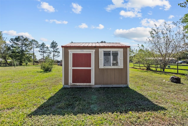 view of outbuilding featuring a yard