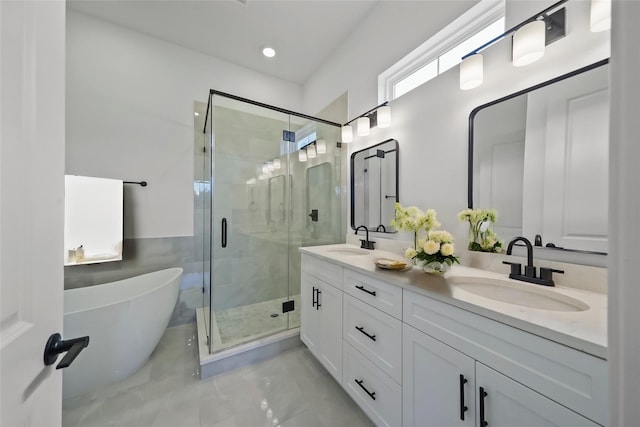 bathroom featuring vanity and shower with separate bathtub