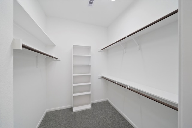 spacious closet featuring dark carpet