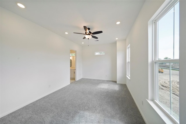 carpeted empty room featuring ceiling fan