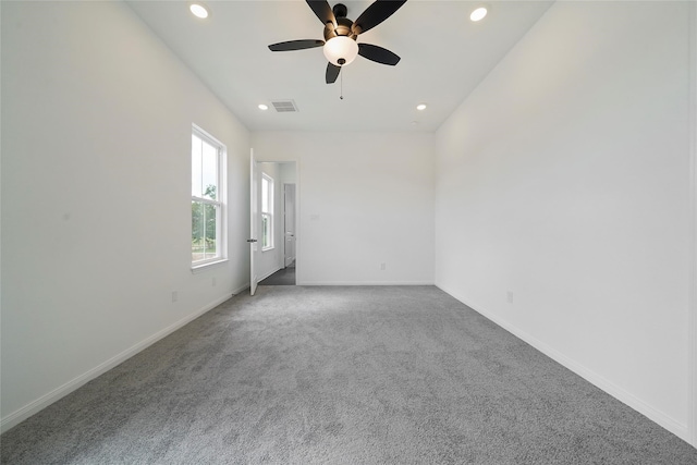 carpeted spare room featuring ceiling fan