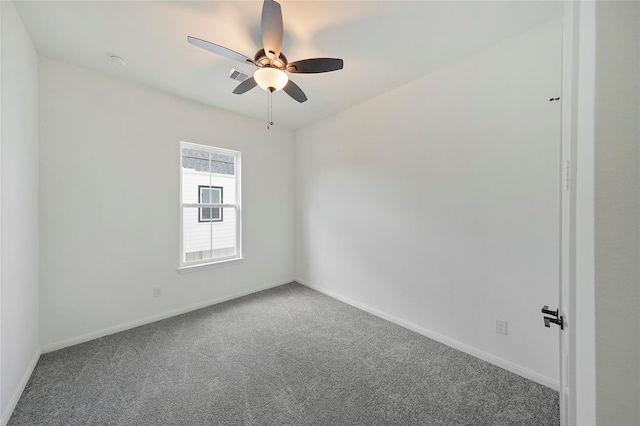 unfurnished room with ceiling fan and carpet