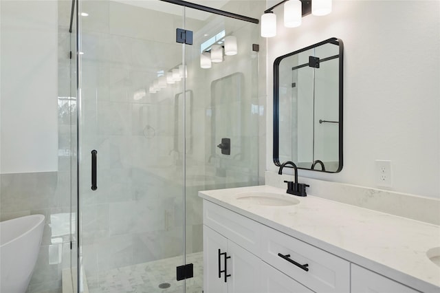 bathroom with vanity and independent shower and bath