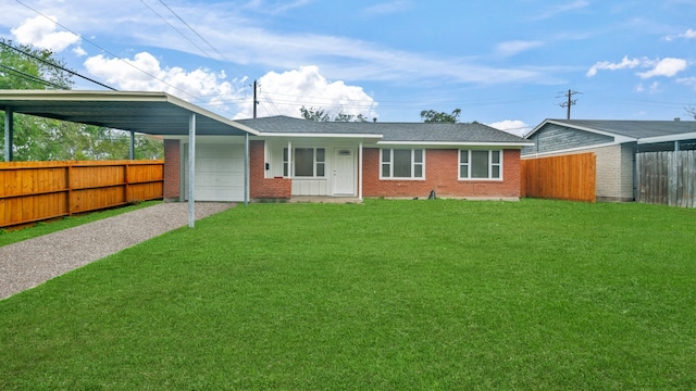 view of front of home with a front lawn, a garage, and a carport