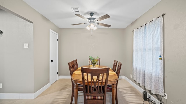 tiled dining area with ceiling fan