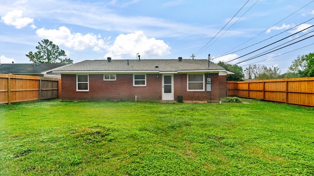 rear view of house with a yard