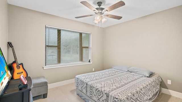 tiled bedroom featuring ceiling fan