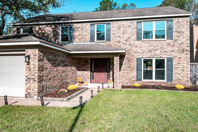 view of front of house featuring a front yard and a garage