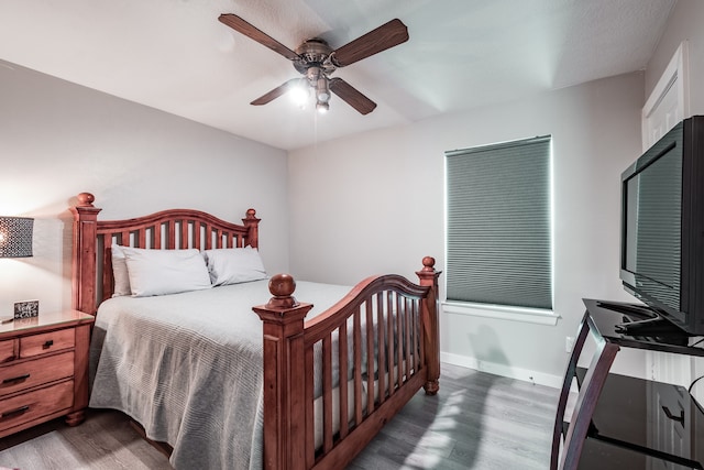 bedroom featuring ceiling fan and dark wood-type flooring