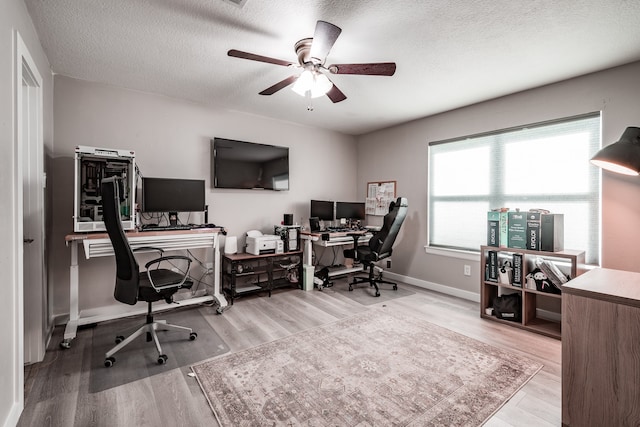 office featuring ceiling fan, wood-type flooring, and a textured ceiling