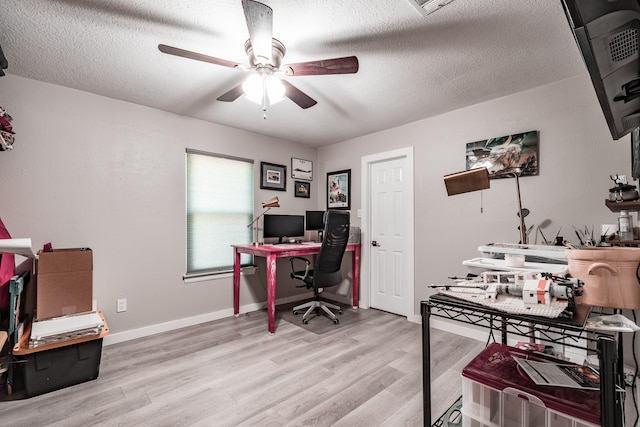 office with ceiling fan, a textured ceiling, and light hardwood / wood-style flooring