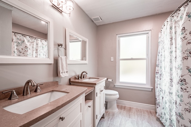 bathroom with vanity, toilet, and walk in shower