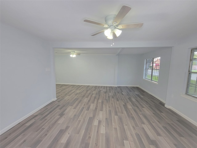 empty room with ceiling fan and hardwood / wood-style floors