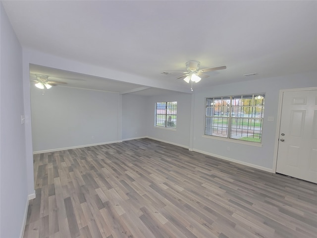 spare room with hardwood / wood-style flooring and ceiling fan