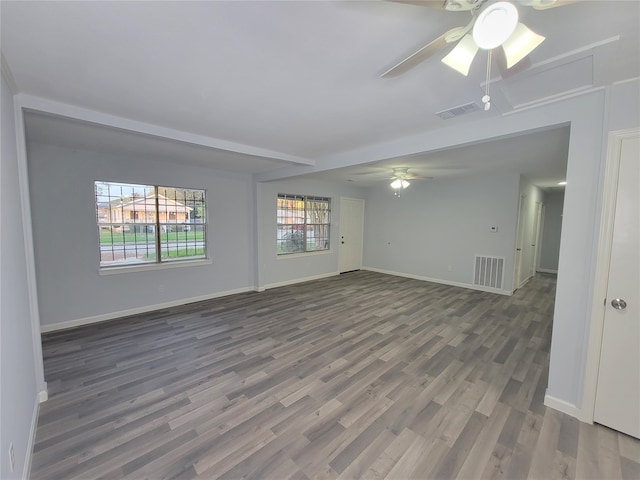 empty room with dark hardwood / wood-style floors and ceiling fan