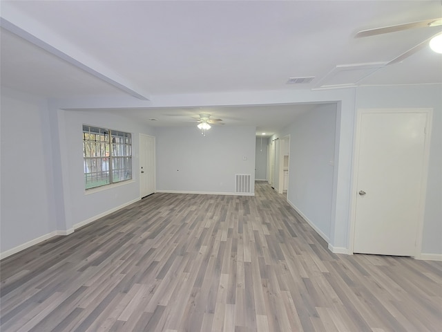 spare room with ceiling fan and light wood-type flooring