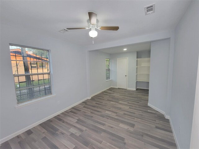 empty room featuring ceiling fan and wood-type flooring