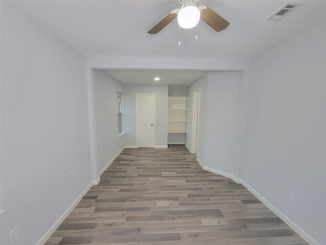 hallway with light hardwood / wood-style floors