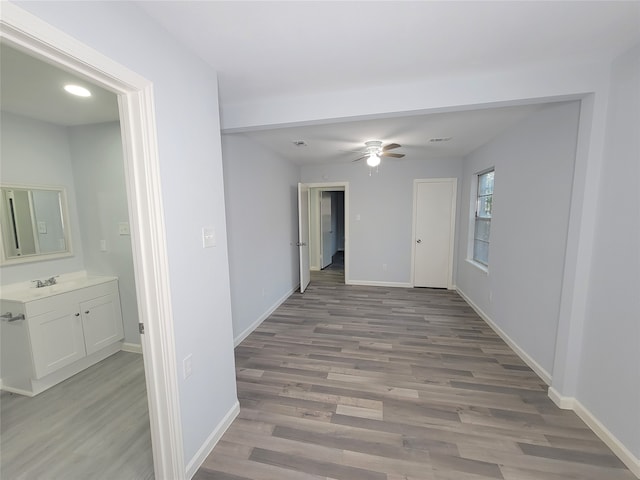 corridor featuring light hardwood / wood-style floors and sink