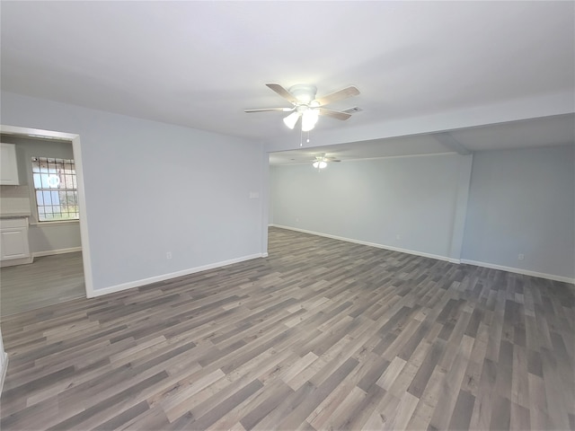 spare room featuring hardwood / wood-style floors and ceiling fan