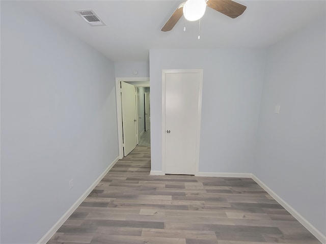 empty room featuring ceiling fan and light hardwood / wood-style floors