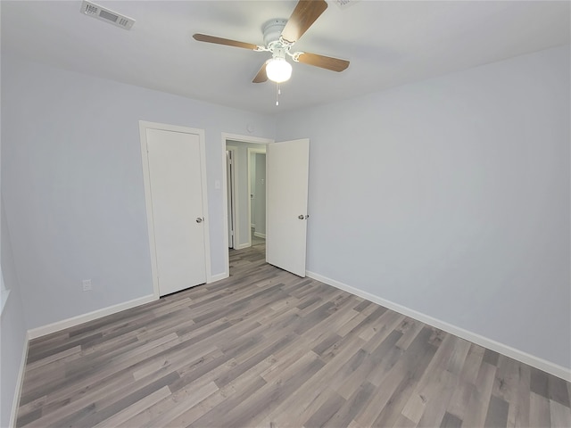 spare room featuring ceiling fan and light hardwood / wood-style flooring