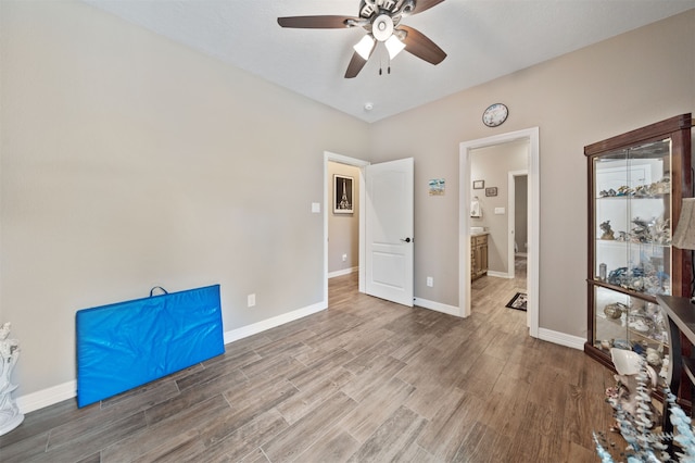 interior space featuring hardwood / wood-style floors, ceiling fan, and ensuite bathroom