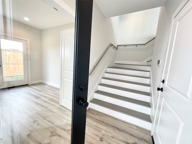 stairway with hardwood / wood-style flooring