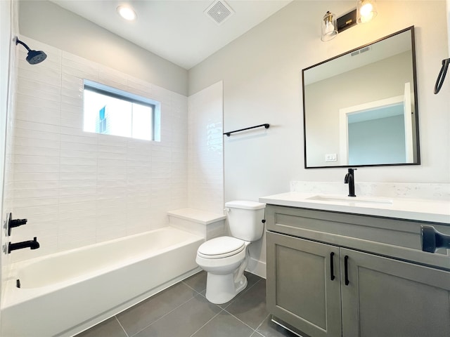 full bathroom featuring tile patterned floors, vanity, tiled shower / bath combo, and toilet